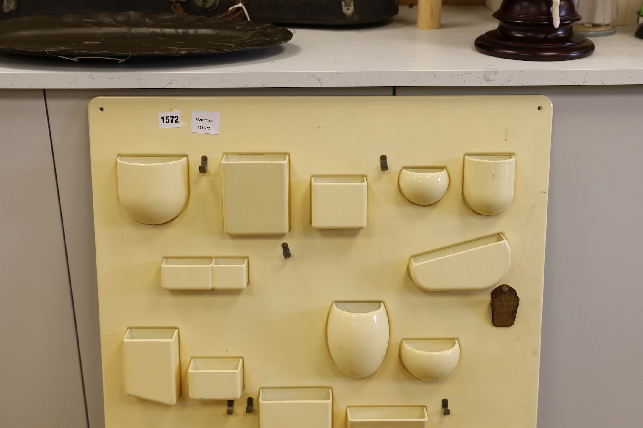 A moulded 20th century Italian composite wall hanging pocket store, 87x67cm